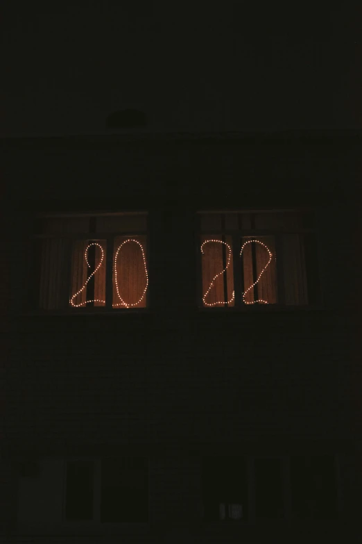 two windows that are decorated with lights