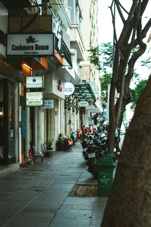 a sidewalk is lined with bikes parked in a row