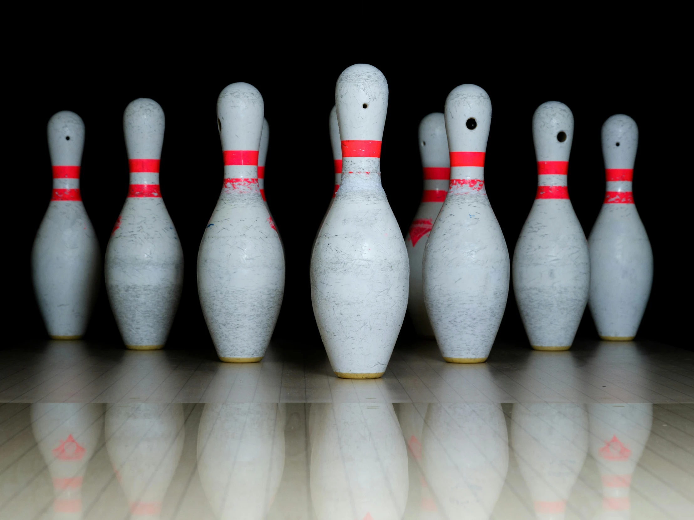 several bowling pins lined up in front of each other