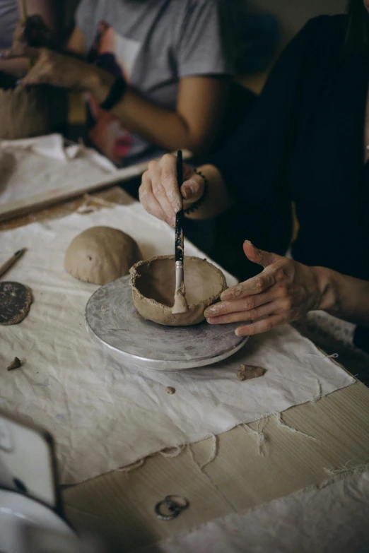 a woman is  up some food in a bowl