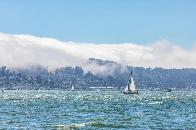 the sailboat is sailing near the small island