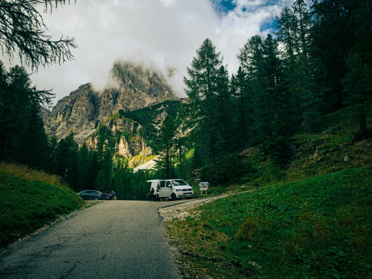 a large mountain covered in trees and clouds