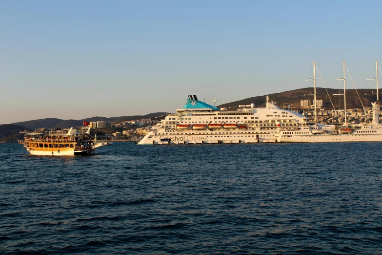 two cruise ships are seen at the edge of the water