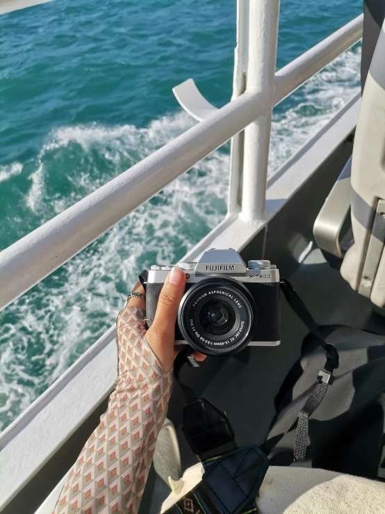 person taking po on board a boat with camera