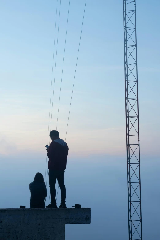 a man is standing on the edge of a large building