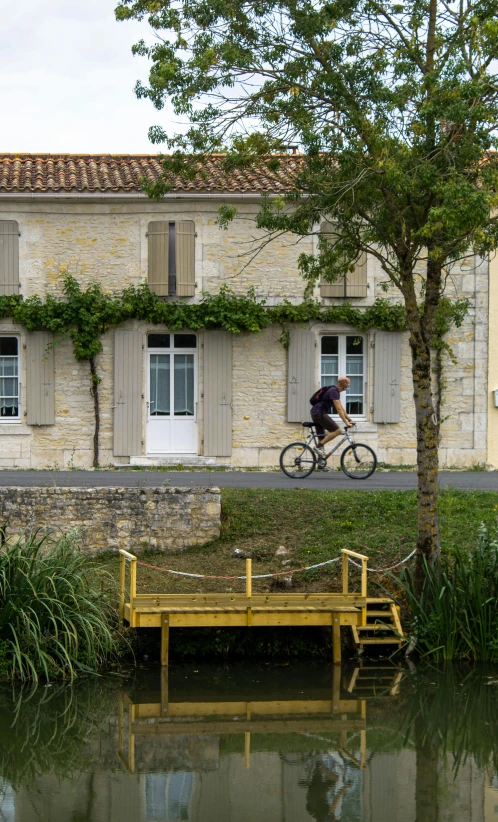 a building and a bicycle are parked near the water