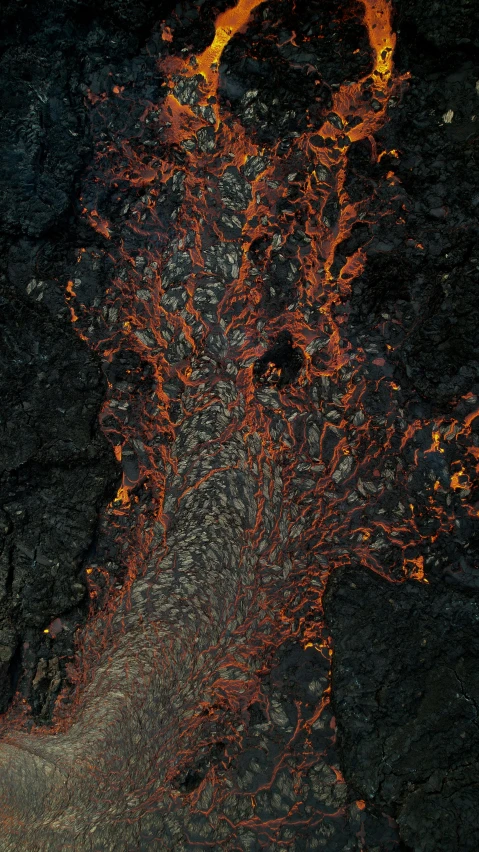 a satellite image of a lava tube with large red vents and orange lava