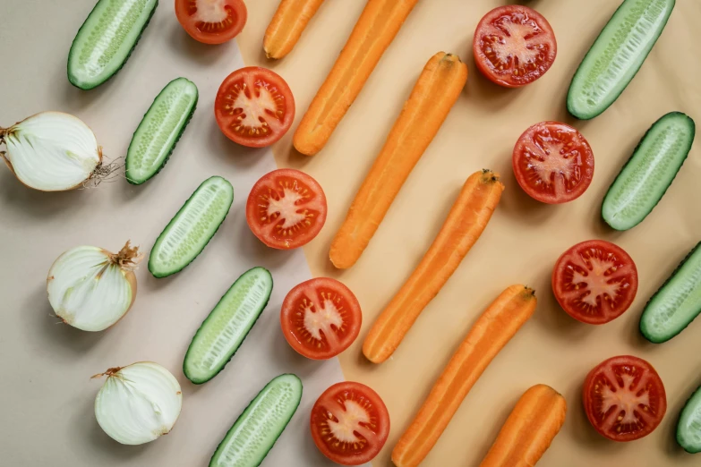 a white counter with cucumbers, tomatoes and other vegetables