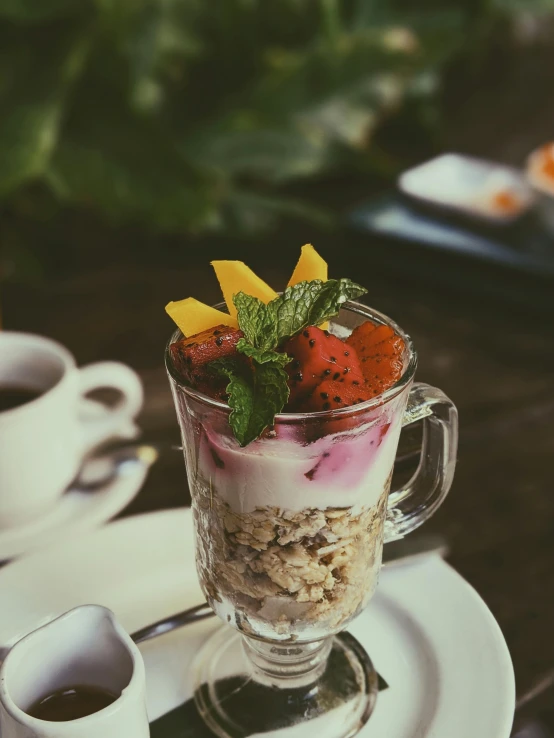 a breakfast scene has strawberries, milk and granola