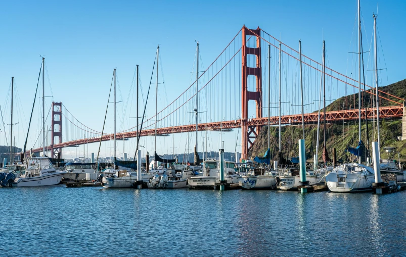 the golden gate bridge in san francisco with boats tied up