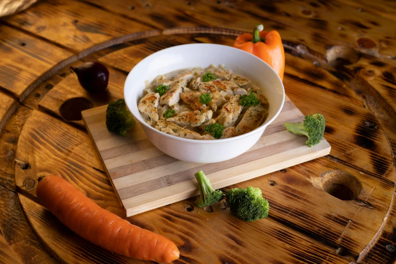 a bowl full of food and some vegetables