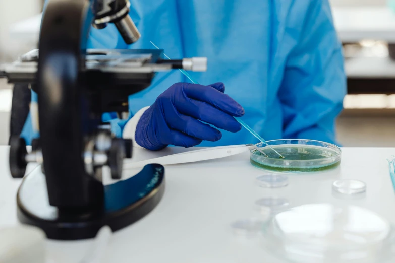 a man working in a lab using a microscope