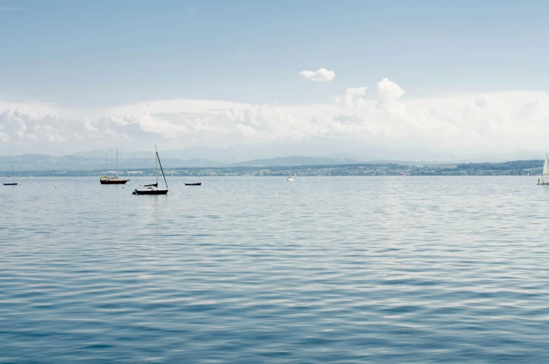 boats floating in the water on a lake