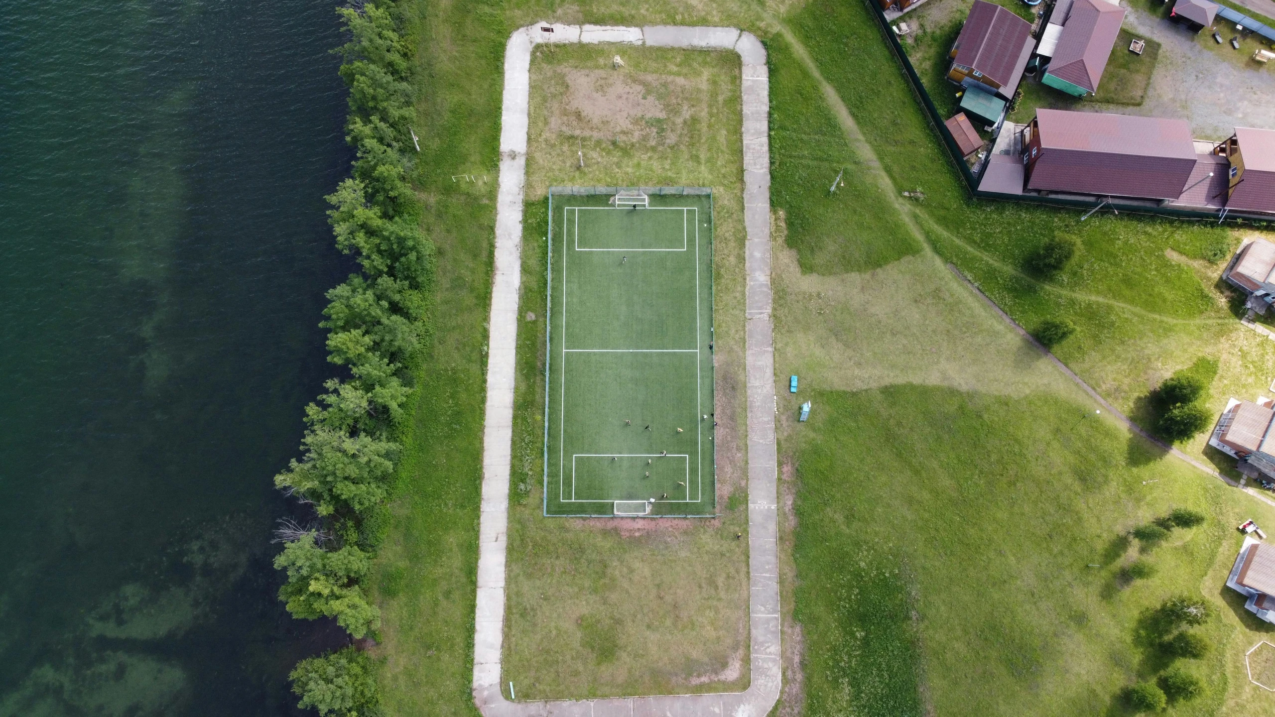 a tennis court that is in the middle of grass