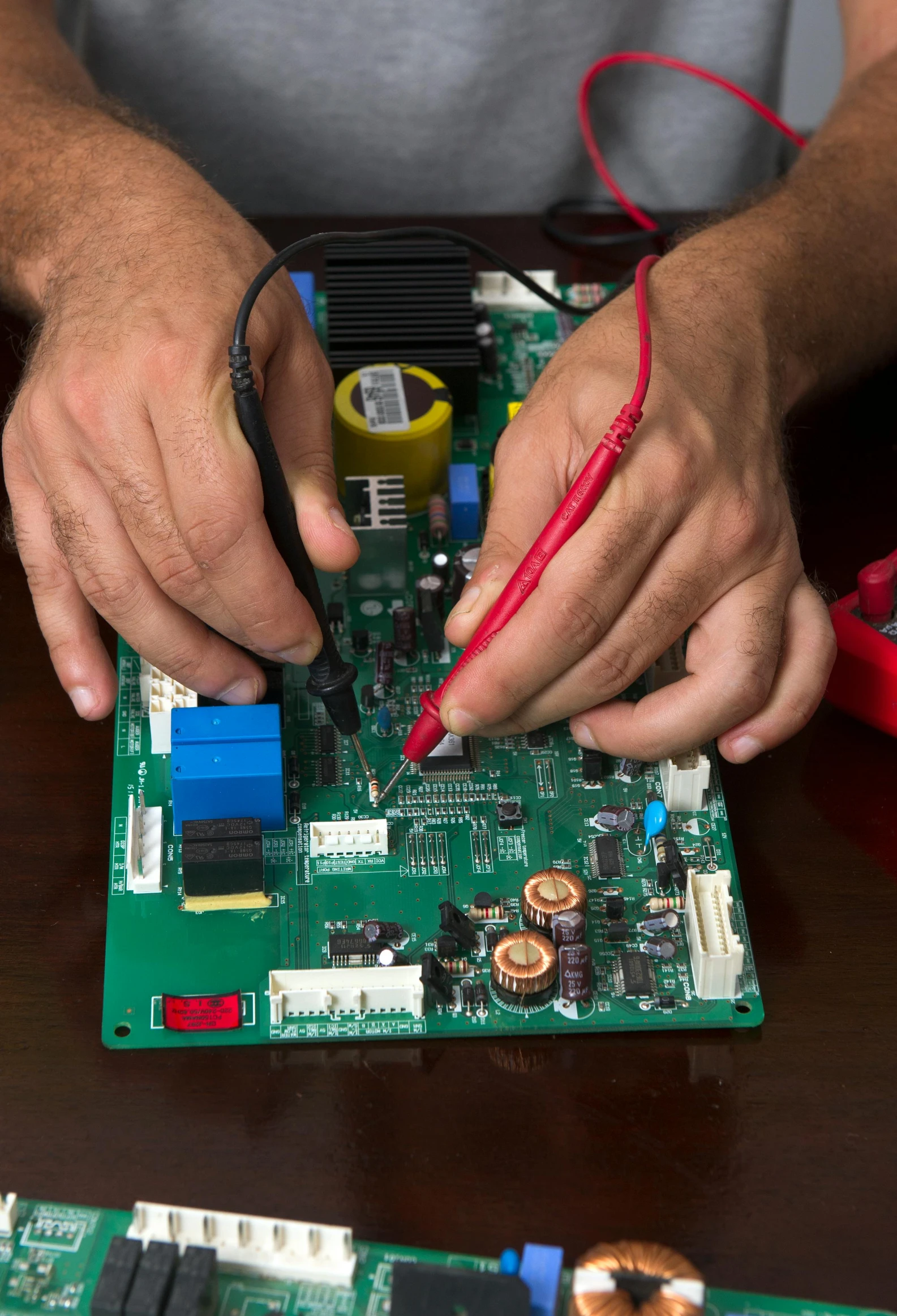 a man with a piece of electronics on top of a table