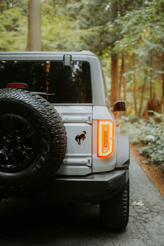 there is a white jeep parked on the side of the road