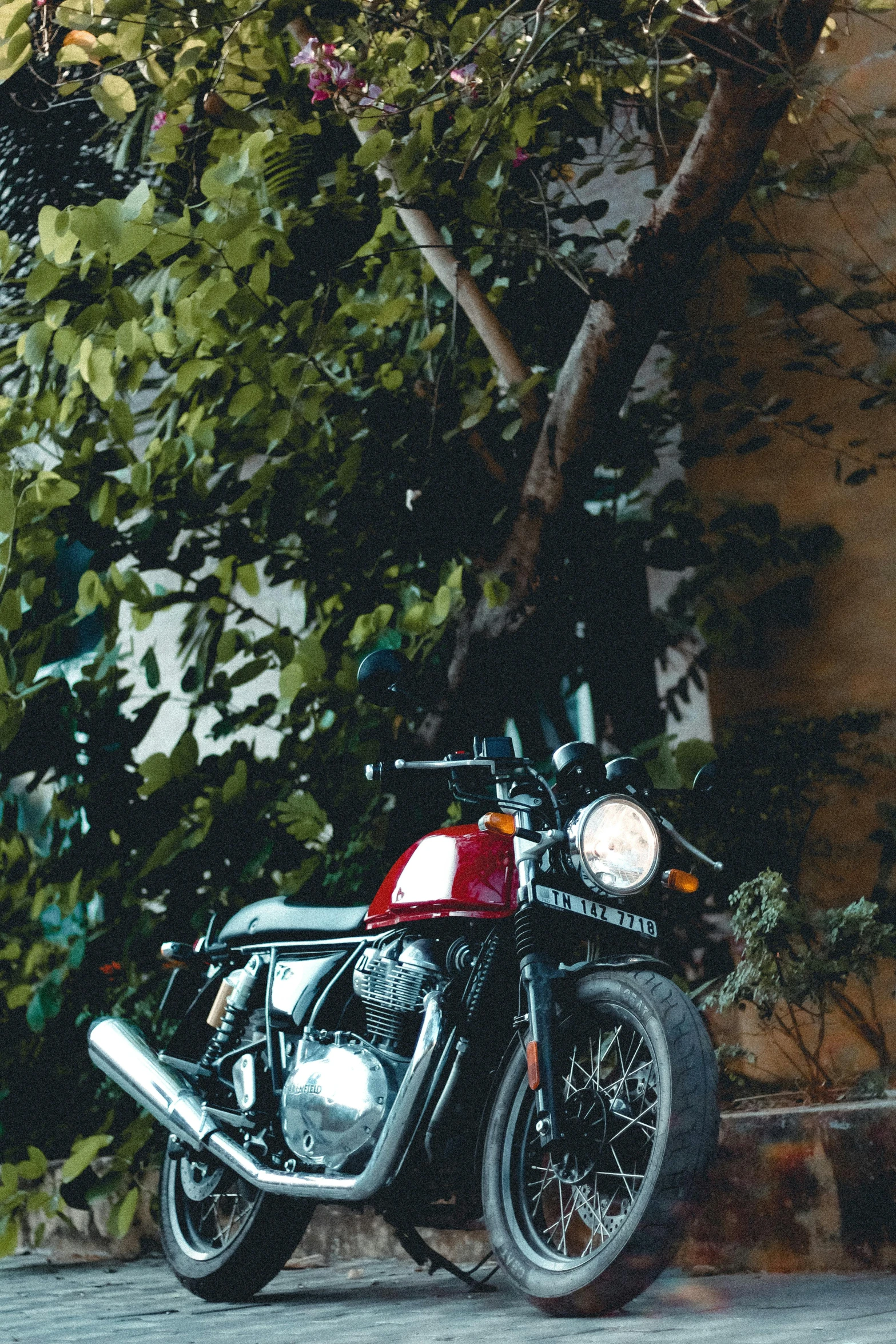 a red and black motorcycle parked in a driveway