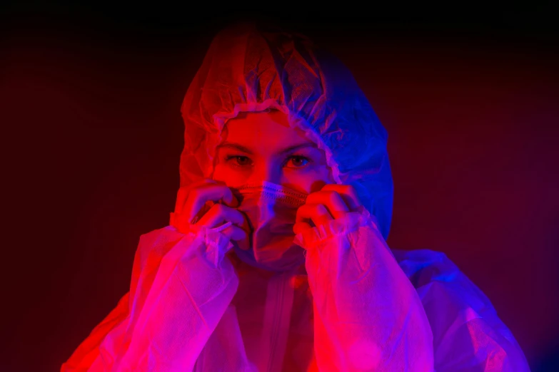 an image of woman in the dark covering her face