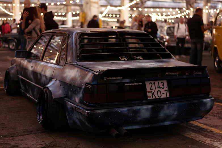 a burnt out car in the middle of a street