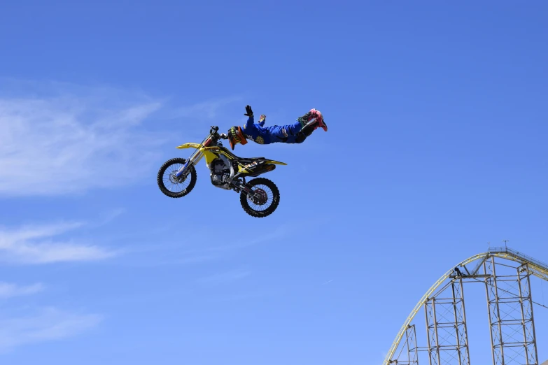 a man riding a dirt bike through the air