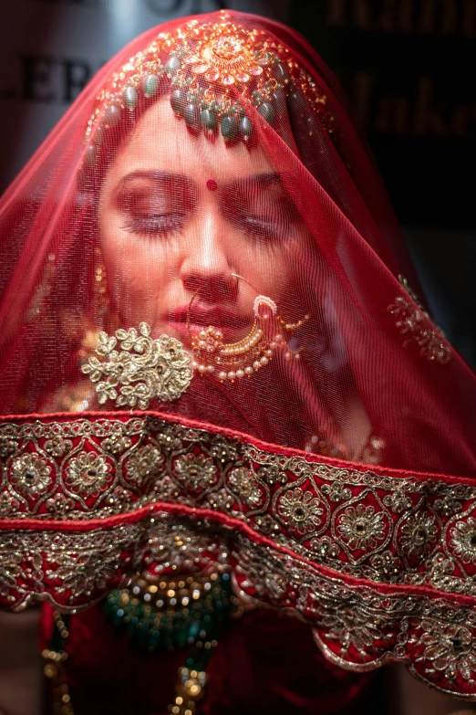 a red veil covered face of a woman