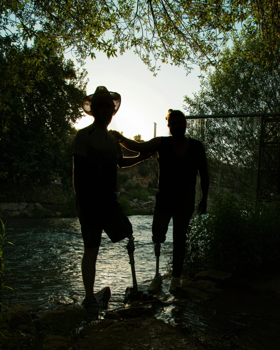 two people walk into a water way while holding hands