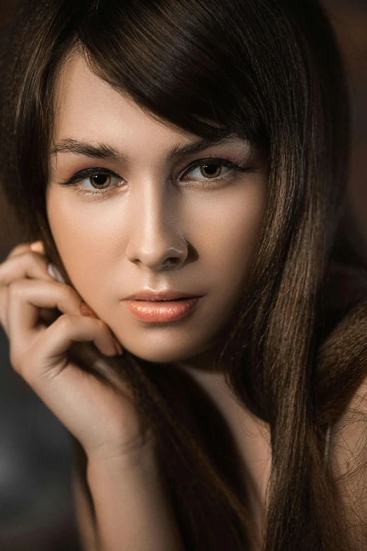 a woman with long hair posing for a pograph