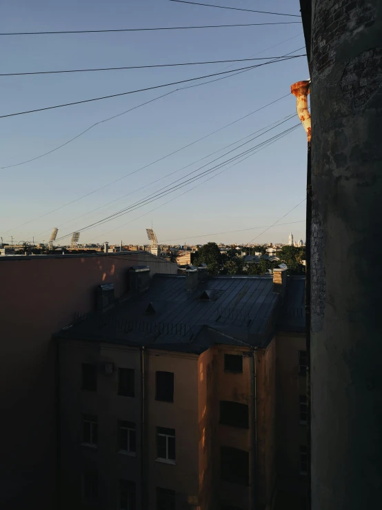 the view from behind a building shows electricity lines
