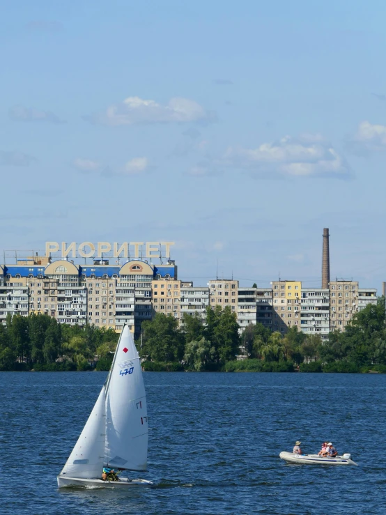 a small boat sailing on top of a lake