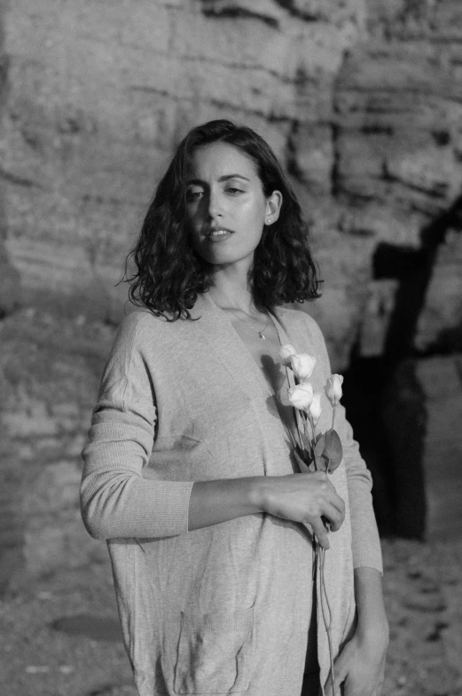 black and white po of young woman with flowers