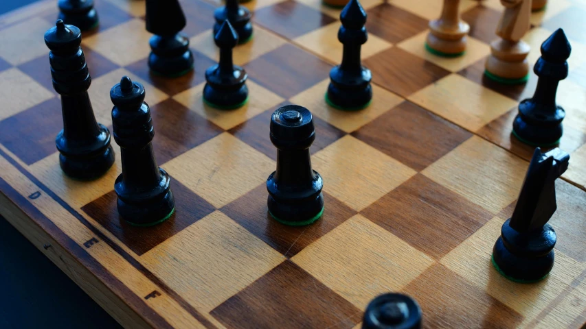 there are several black and brown chess pieces on the board
