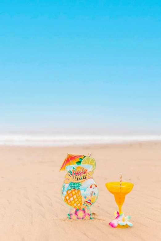 two colorful objects sit in the sand on a beach