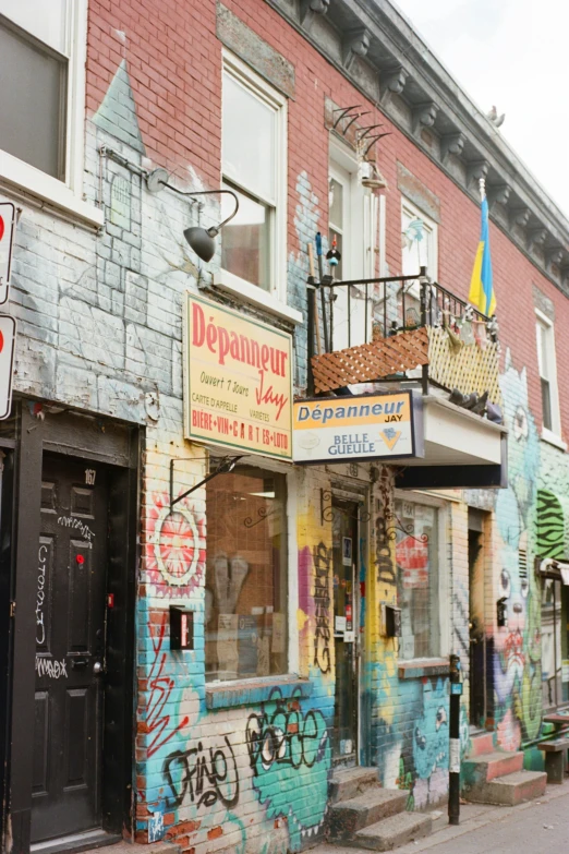 a building covered in graffiti and graffiti written all over the side