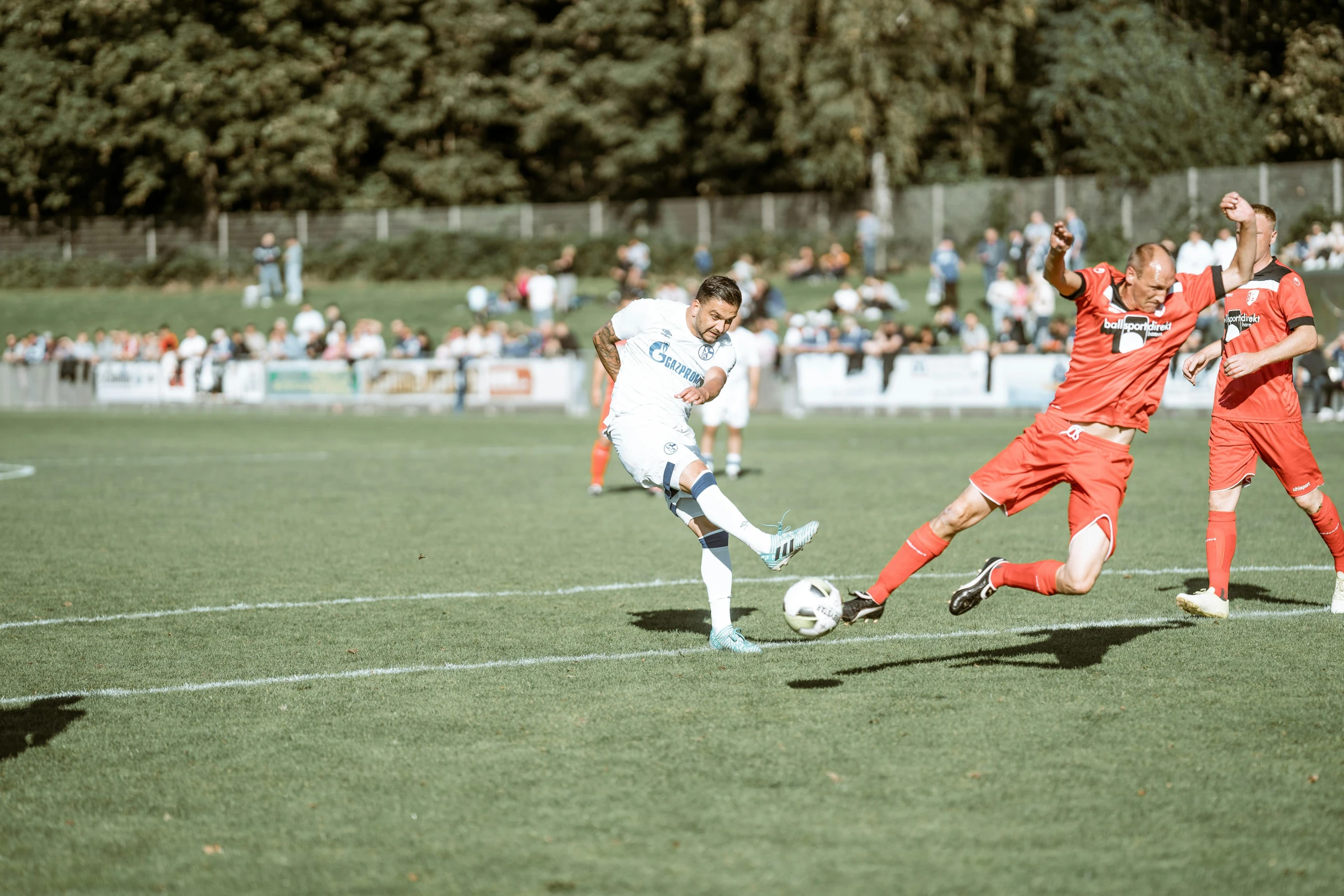 the soccer player has his feet up on the ball