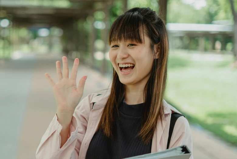 a woman smiles while reading a notebook