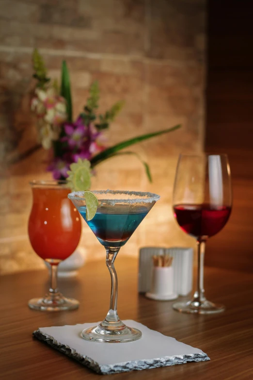 a variety of drinks sit on a wooden table