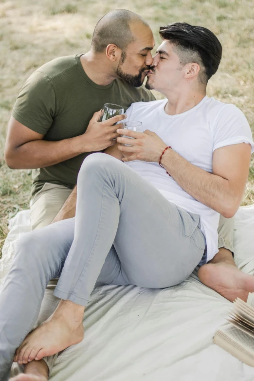 a man and woman kissing in a park