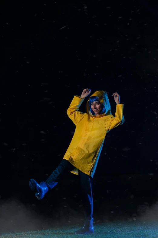 a young person is dancing and laughing in the snow