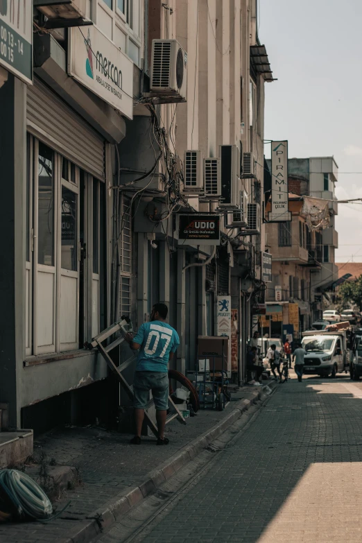 a man is on the sidewalk near some buildings