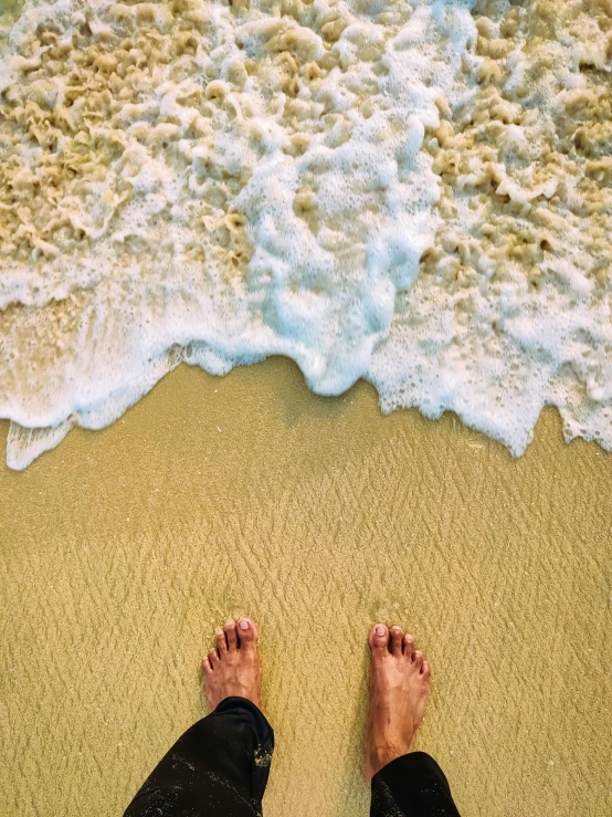 a person with his legs near the water