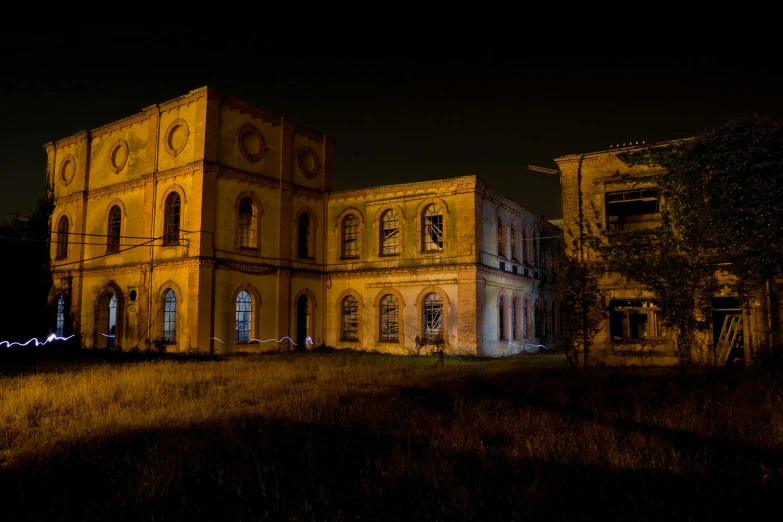 an old building in the middle of a field