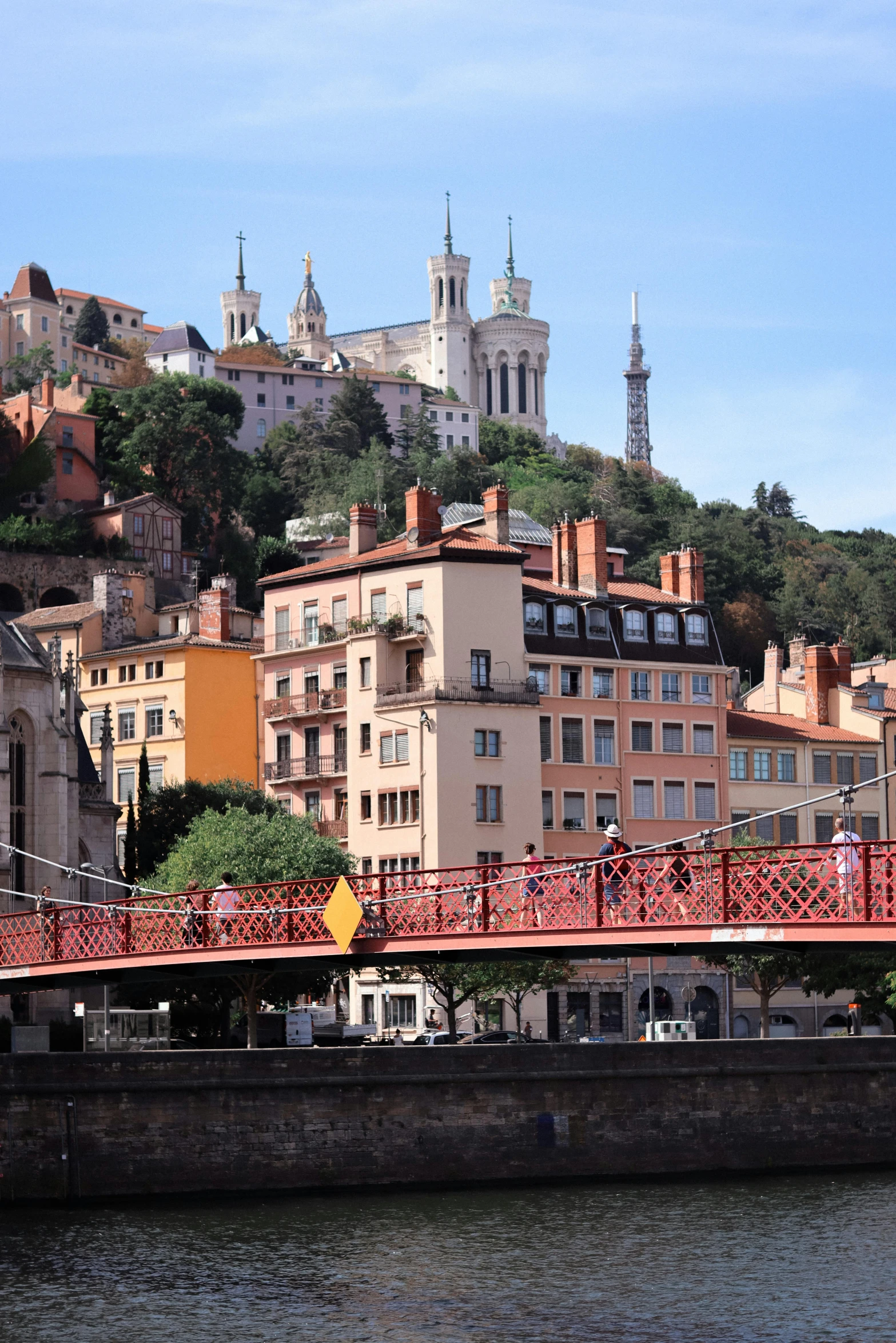 the bridge is red and has a red railing