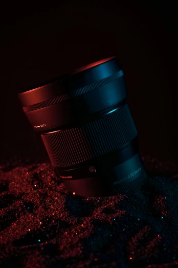the camera lens sitting next to its reflection in a dle of water