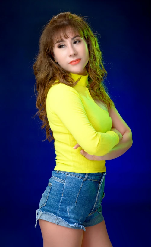 a woman in a yellow shirt is posing for a picture