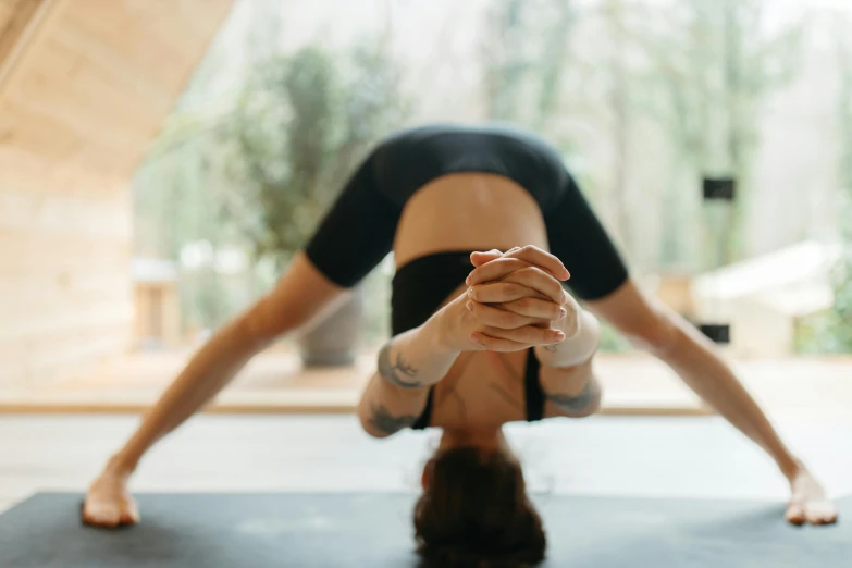 the woman is doing yoga and holding her hands together