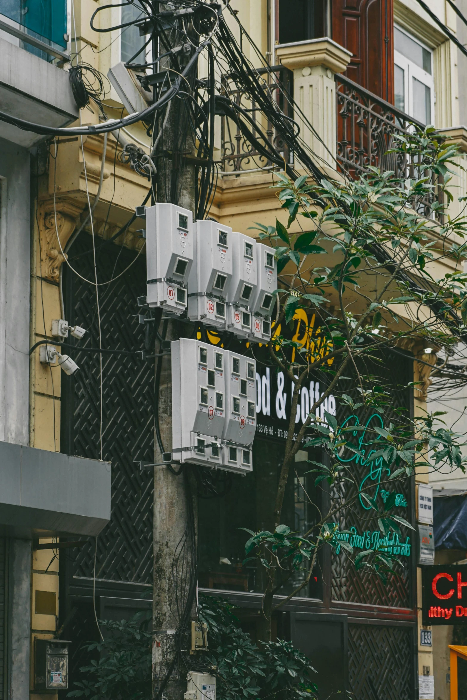 the building is surrounded by electrical wires and trees