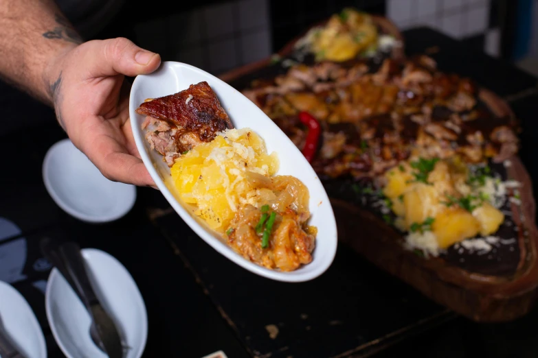 a plate of food being held up with a spoon