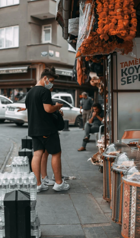 a man in white sneakers is checking his cellphone