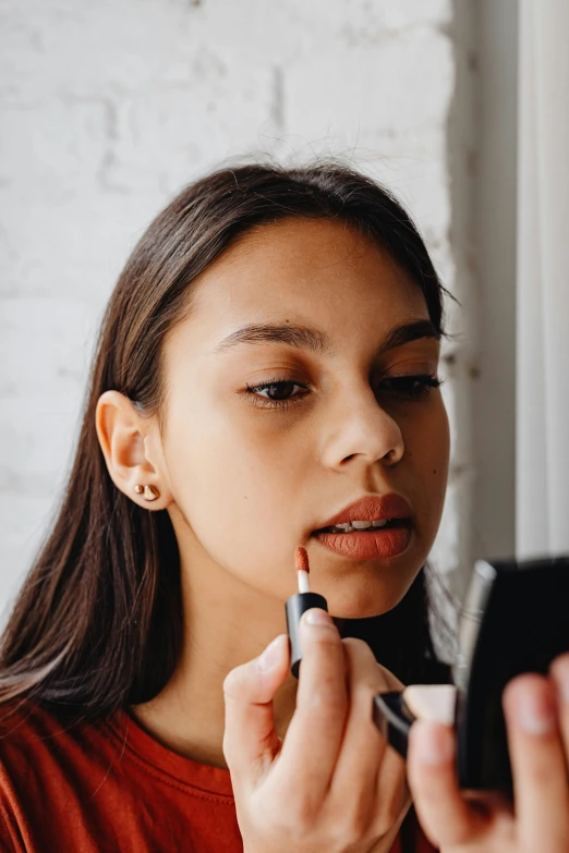 a girl using a phone and lighting a cigarette