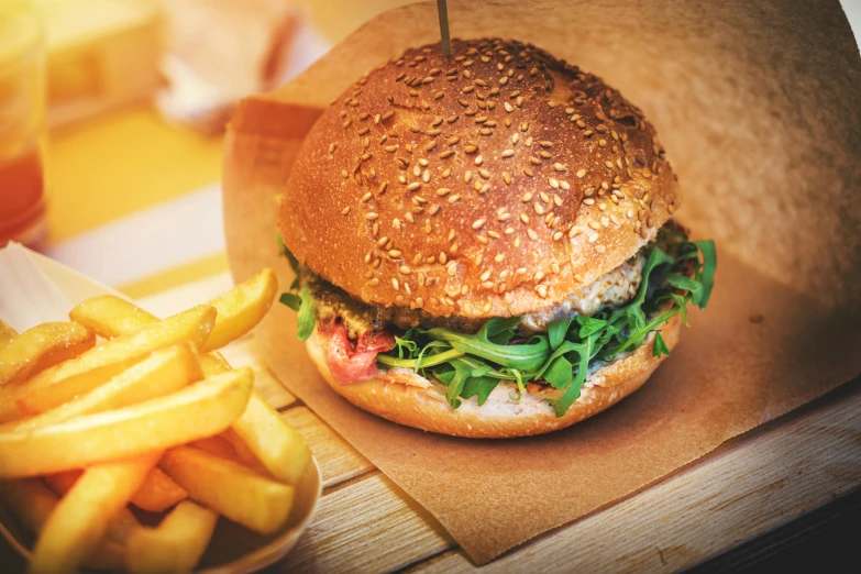 a hamburger is on a table next to fries